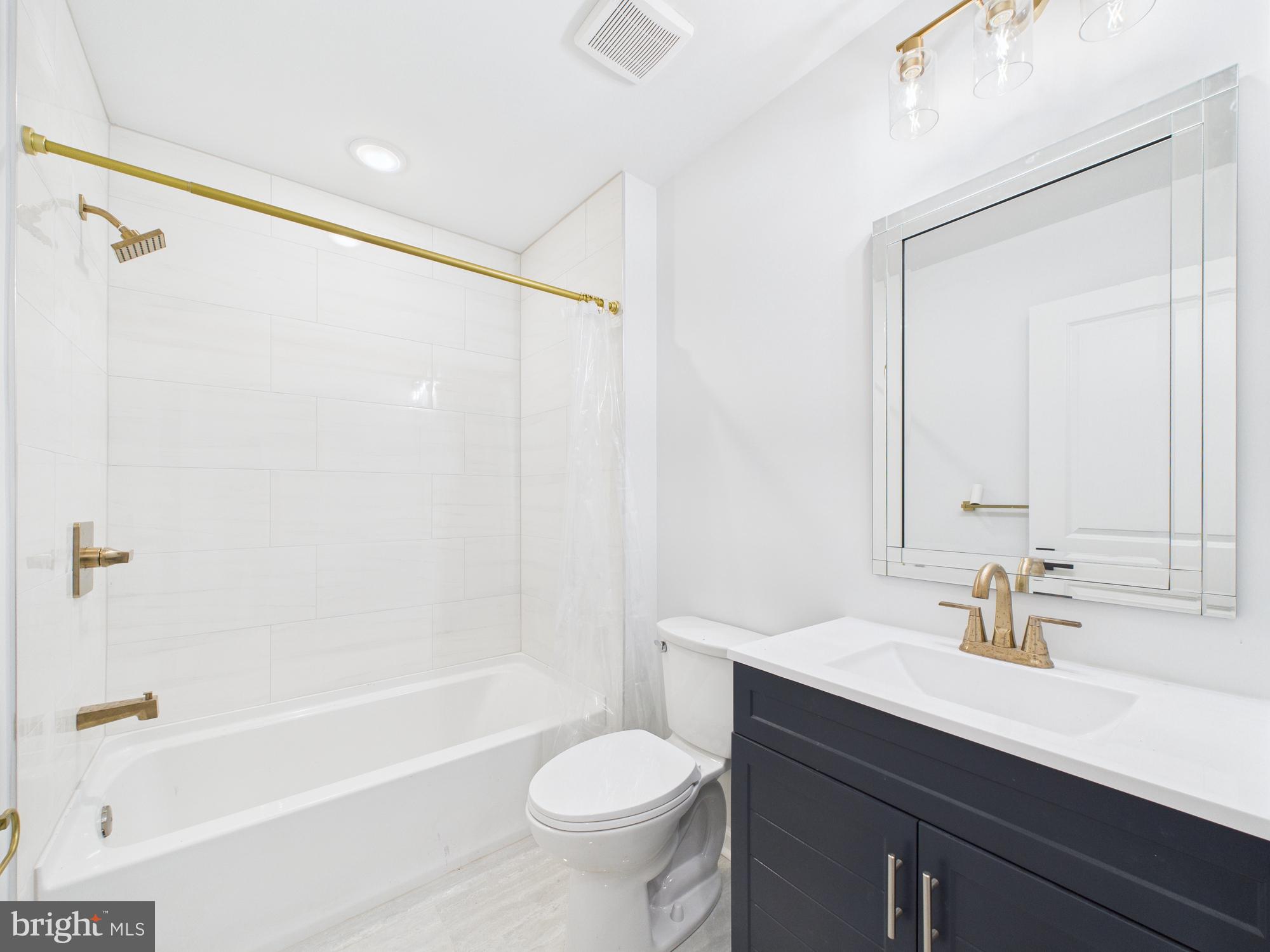1326 Grove Street, Unit 5 Philadelphia, PA 19146 - Photo 11 of 14 a bathroom with a sink toilet and shower