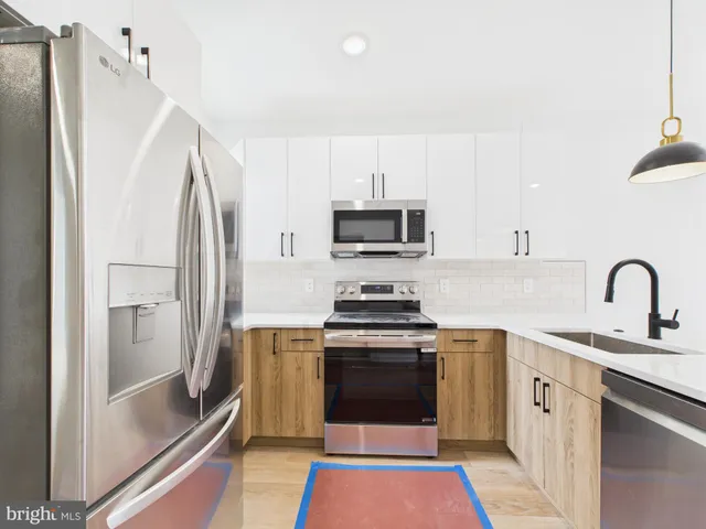 a kitchen with stainless steel appliances a refrigerator sink and microwave