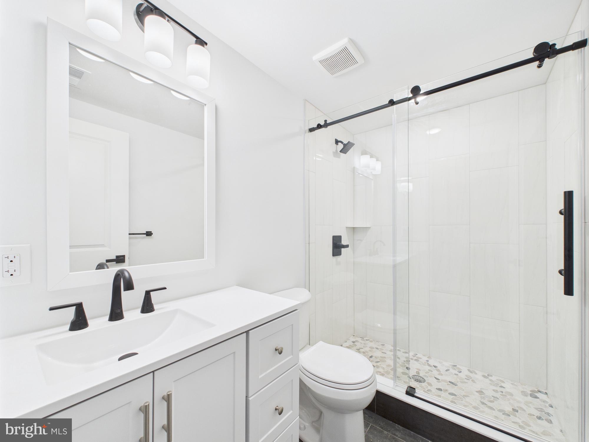 1326 Grove Street, Unit 5 Philadelphia, PA 19146 - Photo 10 of 14 a bathroom with a sink and a mirror