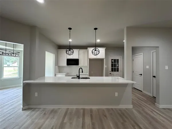 a view of kitchen with cabinets and wooden floor