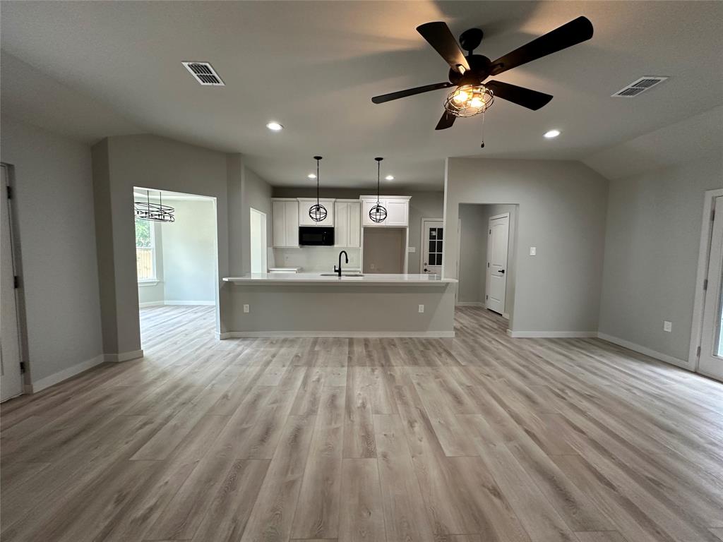 317 North Clark Street Comanche, TX 76442 - Photo 13 of 35 a view of kitchen with cabinets and wooden floor