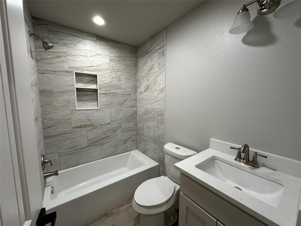 317 North Clark Street Comanche, TX 76442 - Photo 18 of 35 a bathroom with a sink a toilet and shower