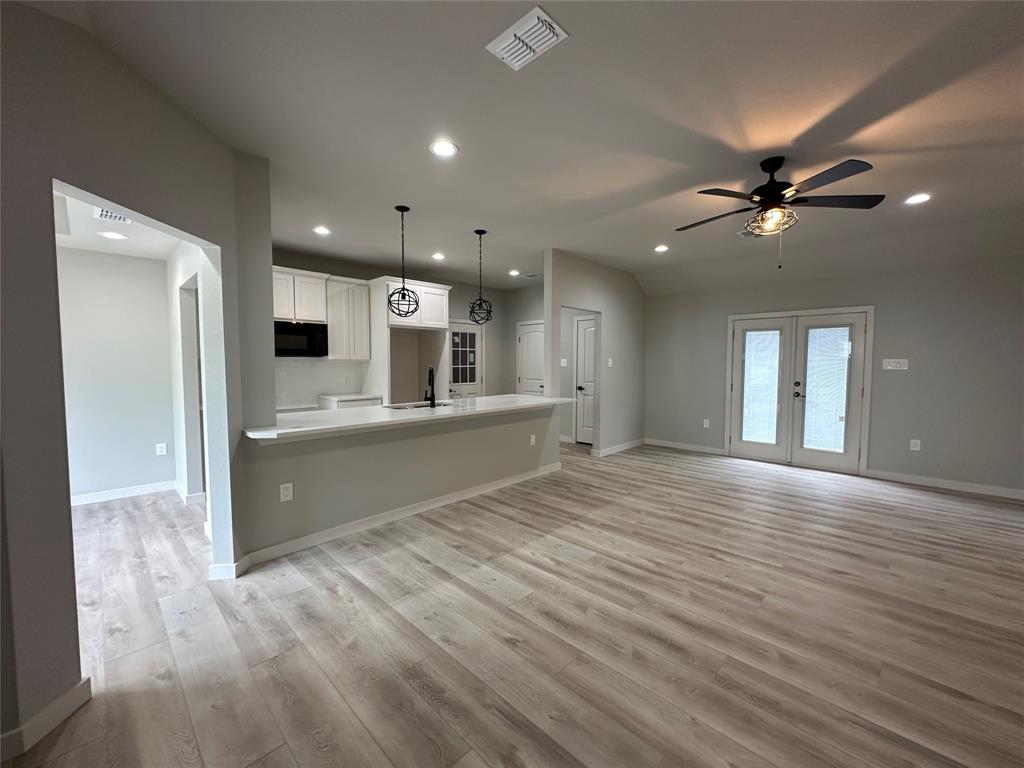 317 North Clark Street Comanche, TX 76442 - Photo 3 of 35 a view of an empty room with kitchen and window