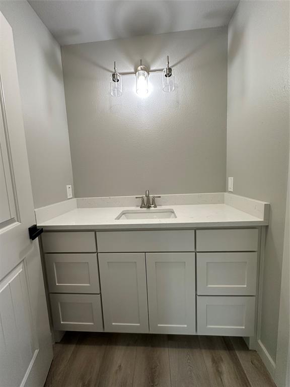 317 North Clark Street Comanche, TX 76442 - Photo 31 of 35 a bathroom with a sink and a mirror