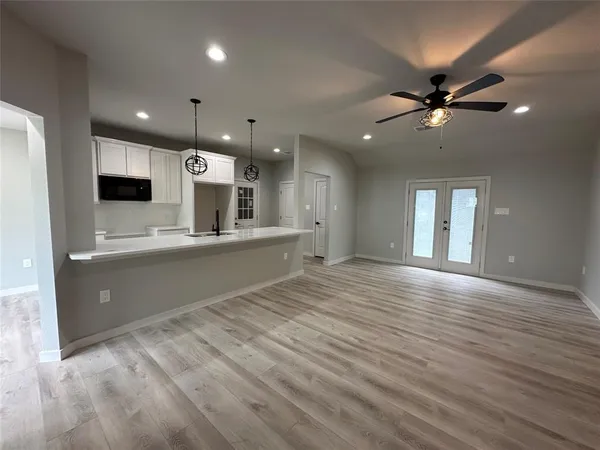 a kitchen with counter top space stainless steel appliances and wooden floor