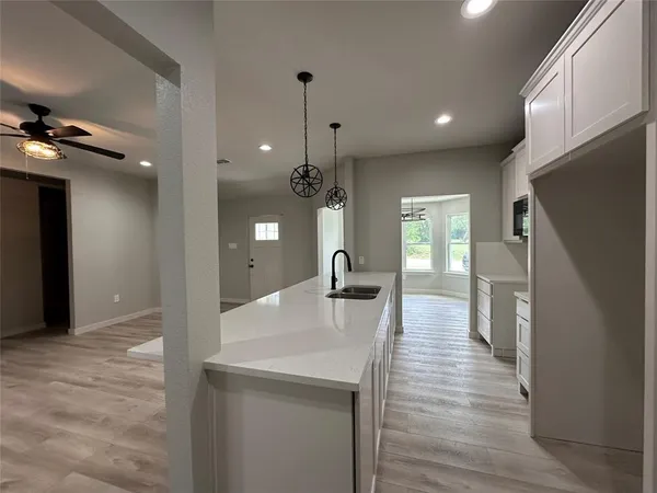 a kitchen with a refrigerator a stove a microwave and cabinets