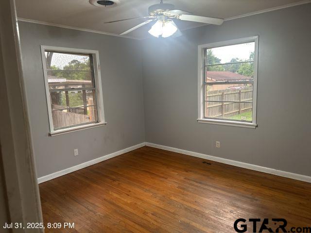 2205 Pine Tree Road Longview, TX 75604 - Photo 20 of 20 a view of an empty room with wooden floor and a window
