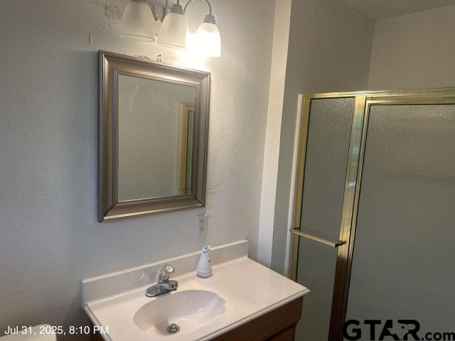 2205 Pine Tree Road Longview, TX 75604 - Photo 10 of 20 a bathroom with a sink and a mirror