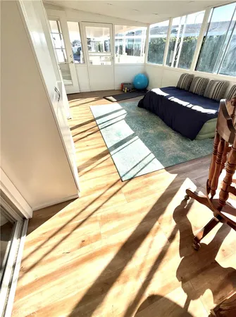 a living room with a couch and floor to ceiling windows