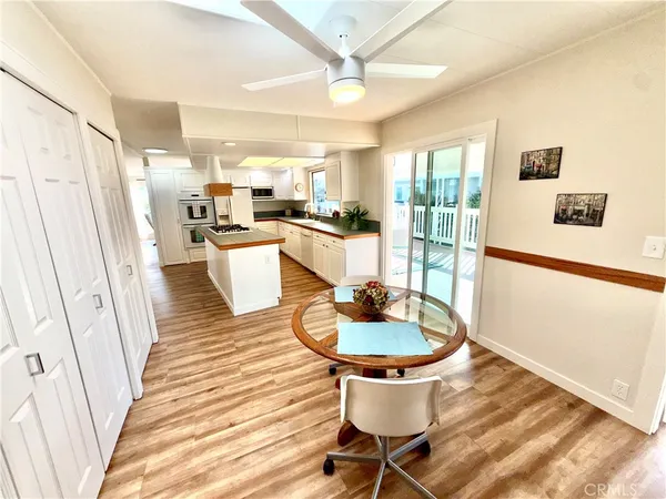 a living room with stainless steel appliances furniture and a table