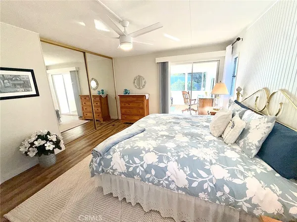 a spacious bedroom with a large bed and a chandelier