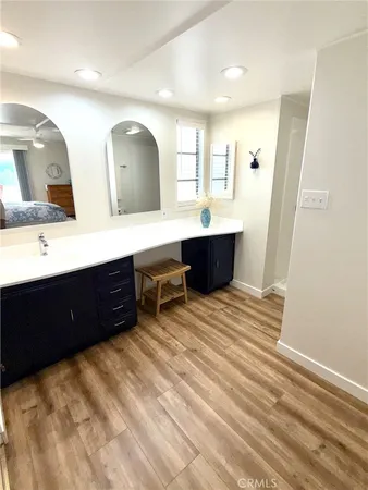 a spacious bathroom with a double vanity sink and a mirror