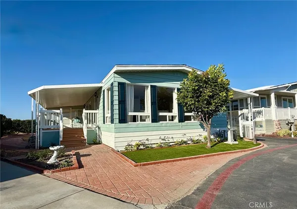 a view of a house with backyard porch and sitting area