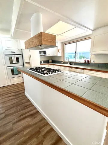 a kitchen with stainless steel appliances a sink and a stove