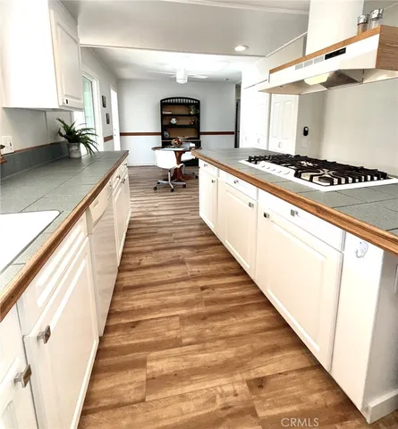 a view of kitchen with sink and wooden floor