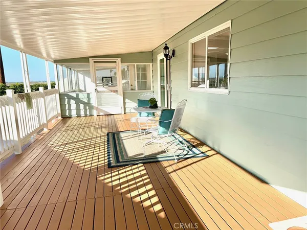 a view of a patio with wooden floor and iron stairs