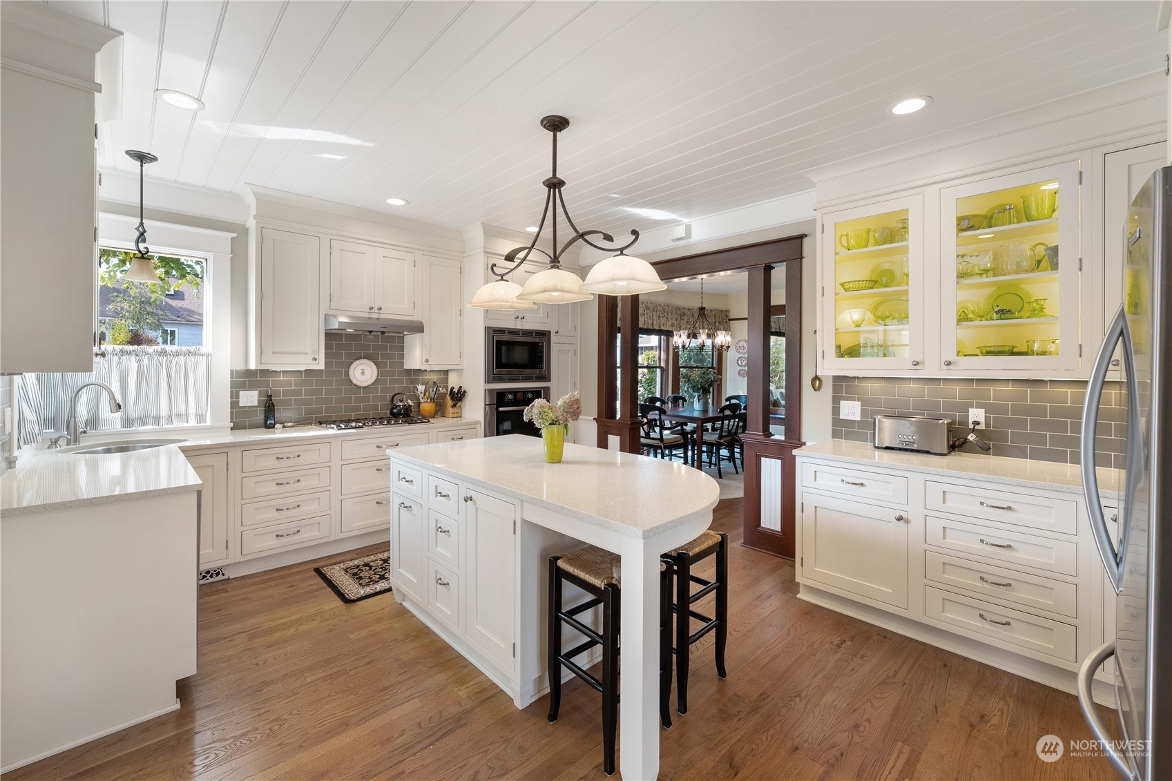 1317 9th Street Anacortes, WA 98221 - Photo 17 of 38 a large kitchen with cabinets a sink a center island and appliances