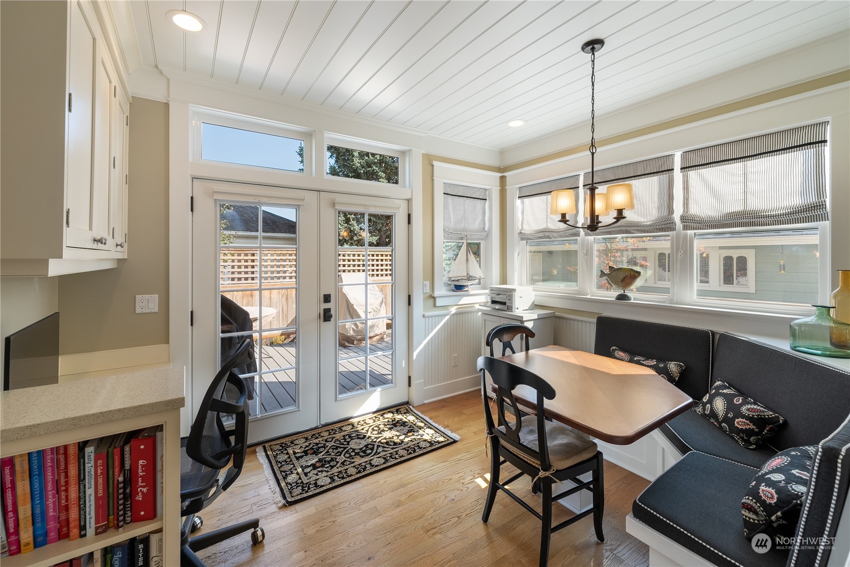 1317 9th Street Anacortes, WA 98221 - Photo 22 of 38 a dining room with furniture a rug and a chandelier