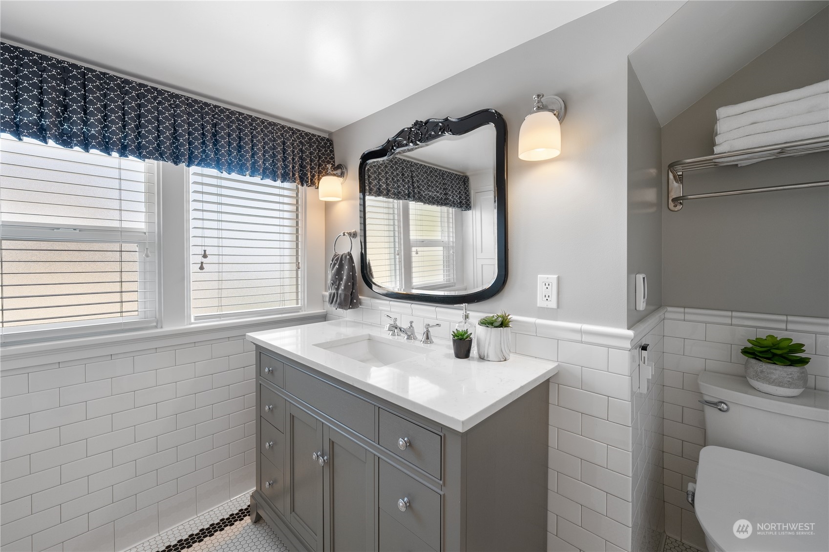 1317 9th Street Anacortes, WA 98221 - Photo 29 of 38 a bathroom with a toilet sink and mirror