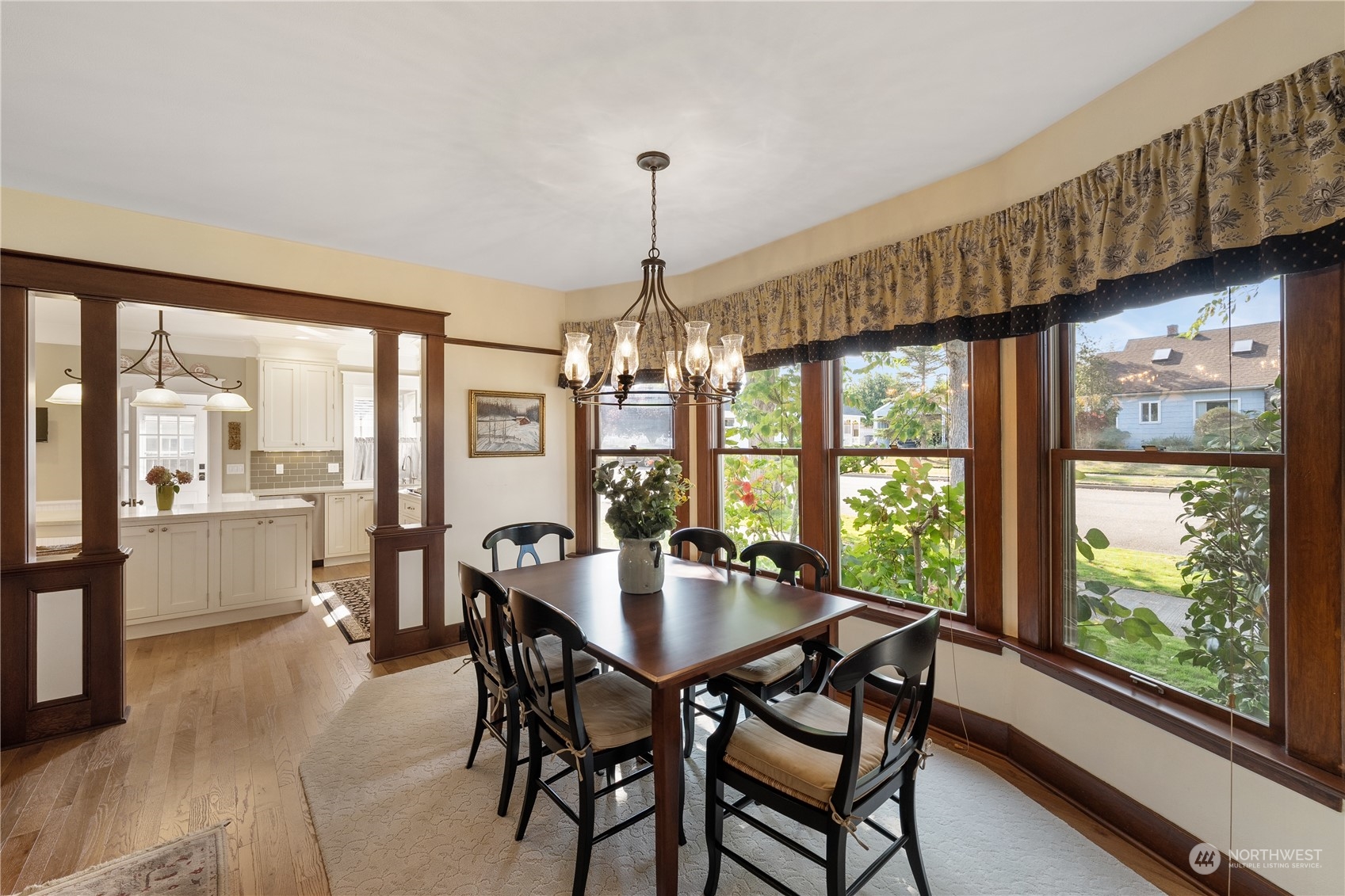 1317 9th Street Anacortes, WA 98221 - Photo 10 of 38 a dining room with furniture window wooden floor and a chandelier