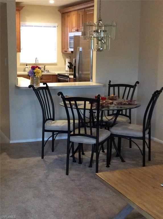170 Turtle Lake Court, Unit 312 Naples, FL 34105 - Photo 3 of 9 a view of a dining room with furniture and a large window