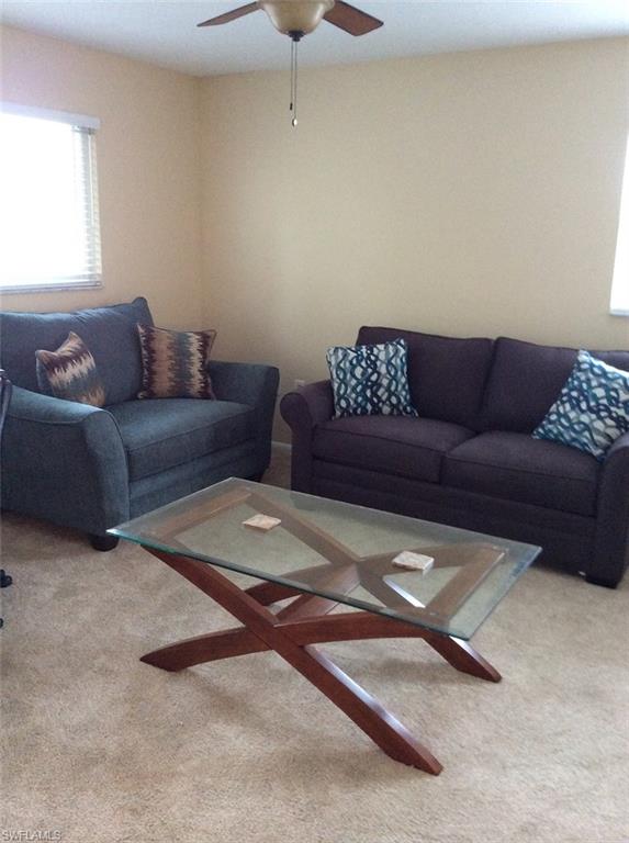 170 Turtle Lake Court, Unit 312 Naples, FL 34105 - Photo 5 of 9 a living room with a couch
