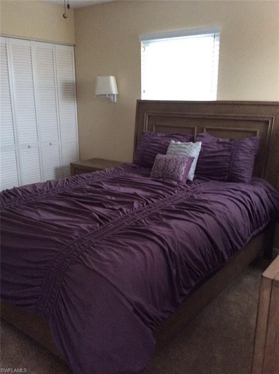 170 Turtle Lake Court, Unit 312 Naples, FL 34105 - Photo 6 of 9 a bed sitting in a bedroom next to a window