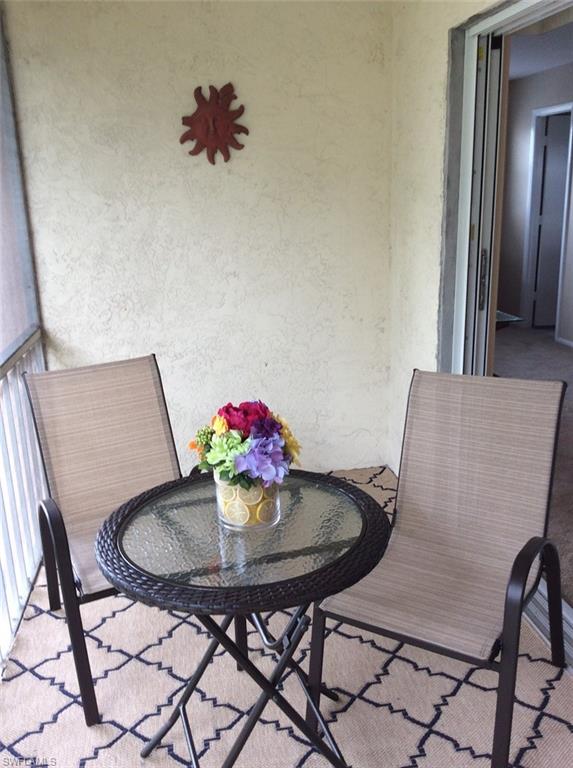 170 Turtle Lake Court, Unit 312 Naples, FL 34105 - Photo 7 of 9 a view of a dining room with furniture and wooden floor