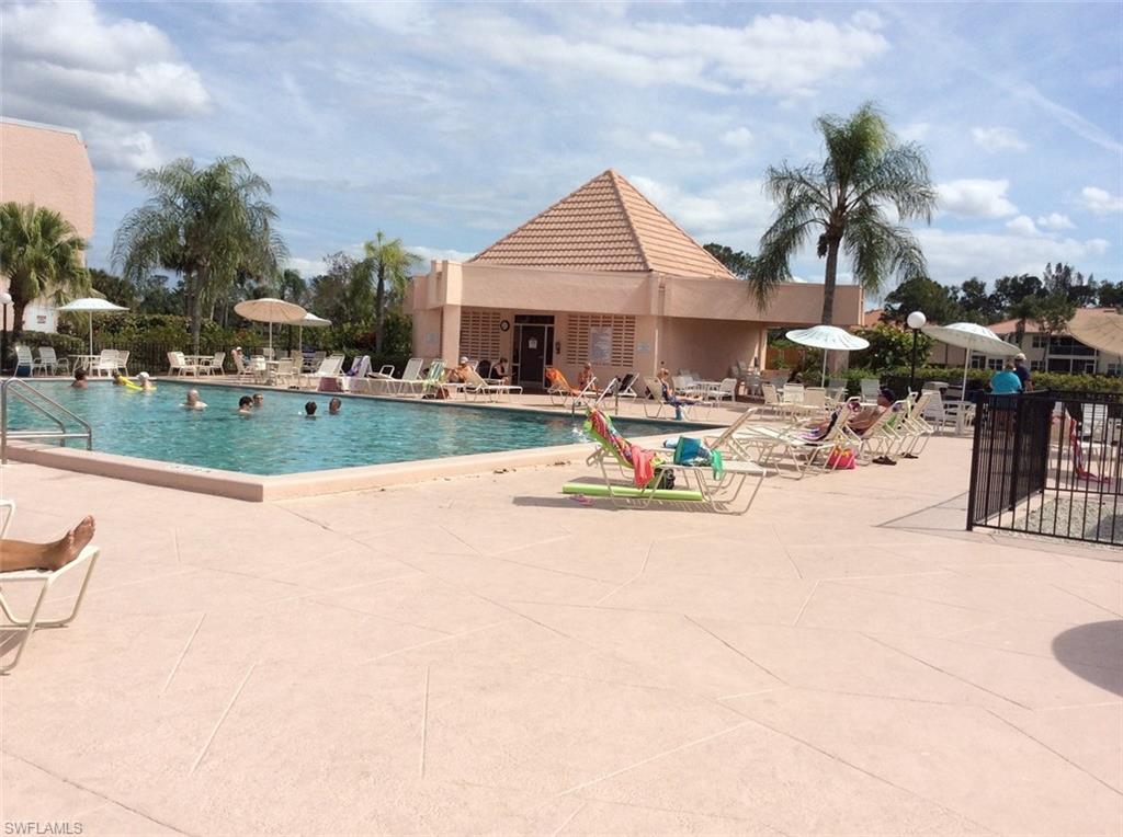170 Turtle Lake Court, Unit 312 Naples, FL 34105 - Photo 8 of 9 a view of a house with sitting area and fire pit
