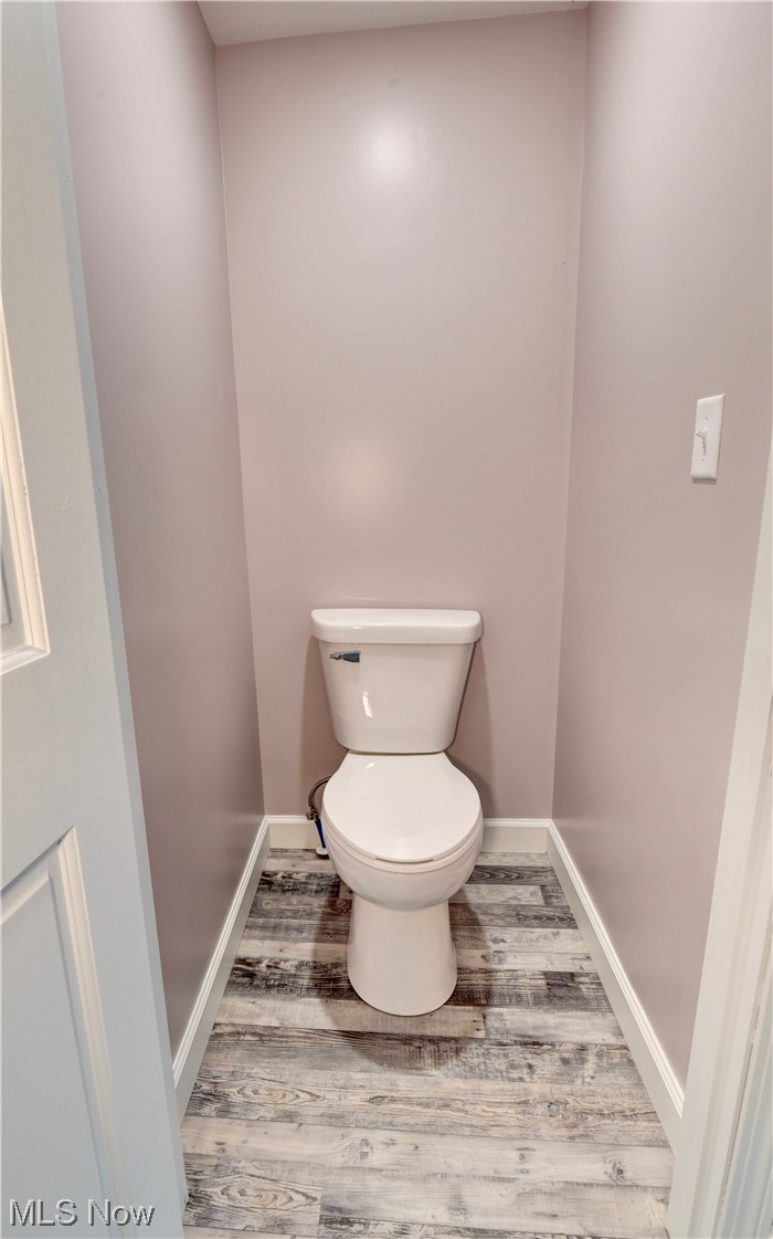 9734 Edwards Ridge Road Southeast Uhrichsville, OH 44683 - Photo 19 of 35 Bathroom with hardwood floors and toilet