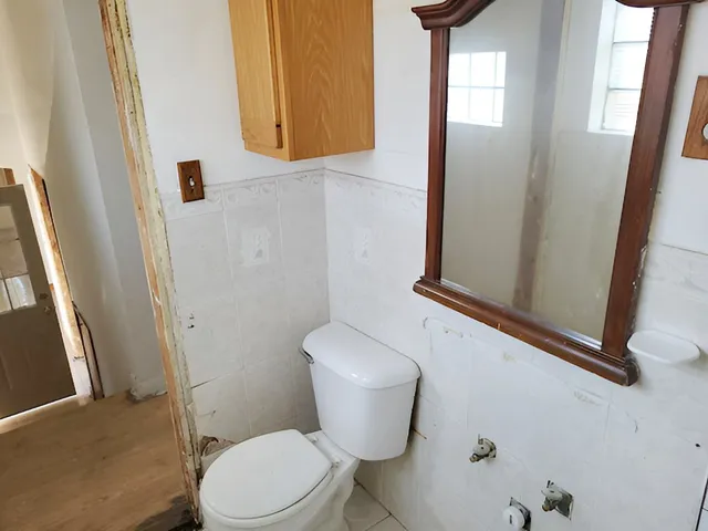 a white toilet sitting next to a bathroom sink
