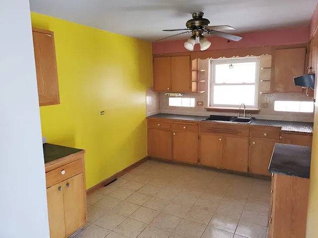 a kitchen with a sink a counter top space stainless steel appliances and a window