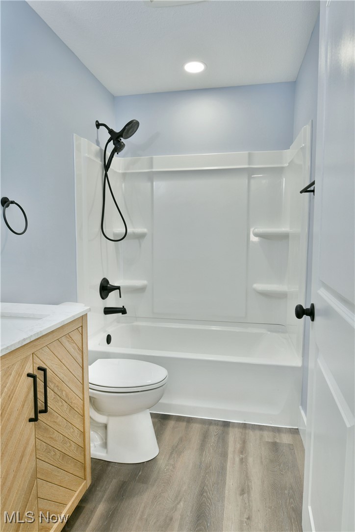 2096 Stillwagon Road Southeast Warren, OH 44484 - Photo 28 of 50 Full bath featuring vanity, toilet, wood finished floors, and shower / washtub combination