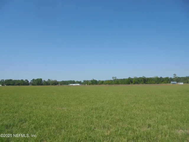 a view of a lake with houses in the background