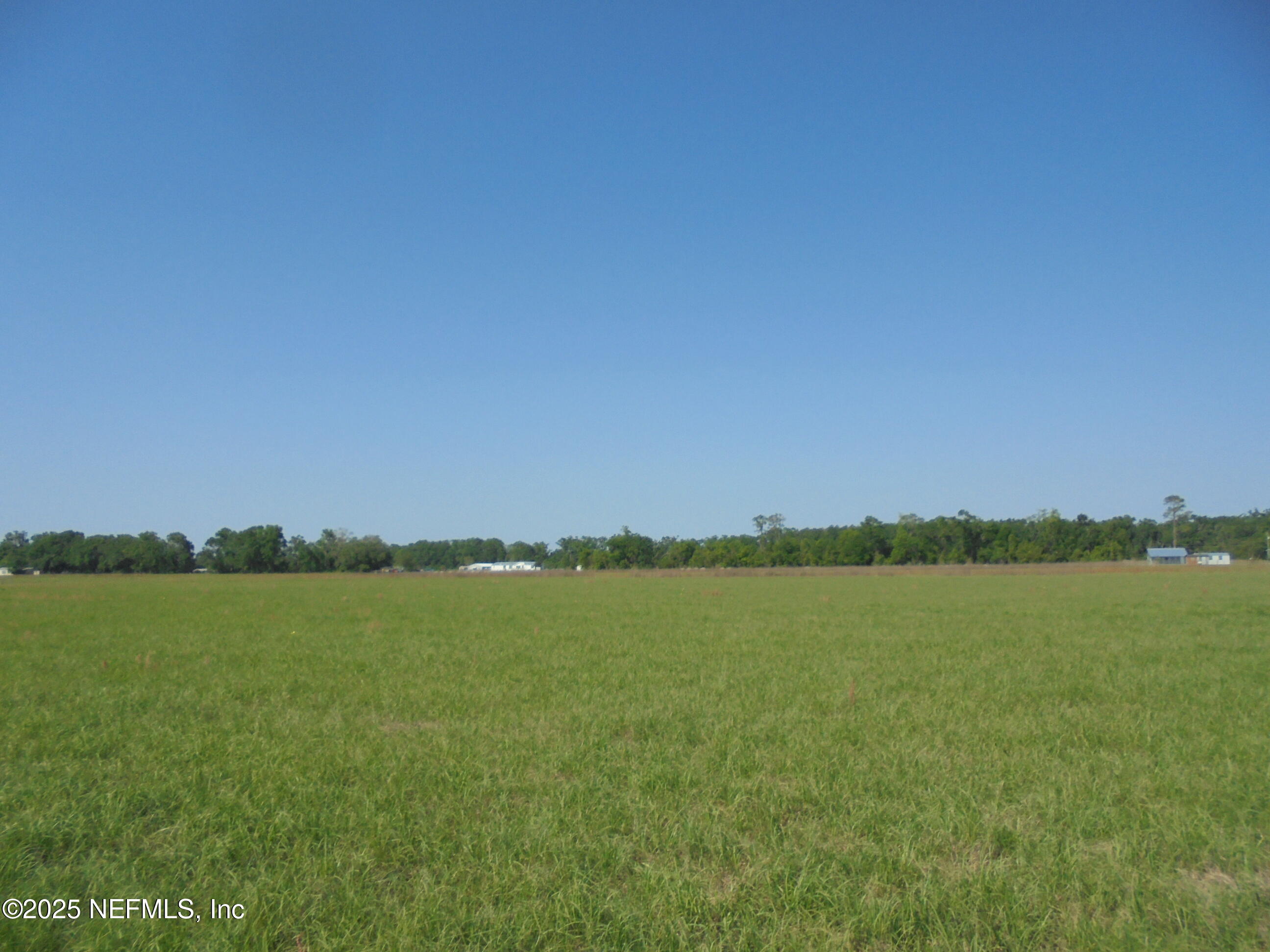 8516 240th Street O'Brien, FL 32071 - Photo 3 of 12 a view of a lake with houses in the background