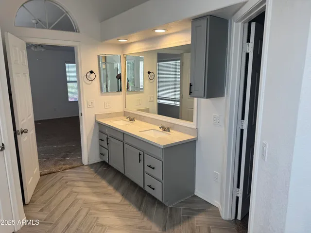 a bathroom with a sink mirror vanity and bathtub