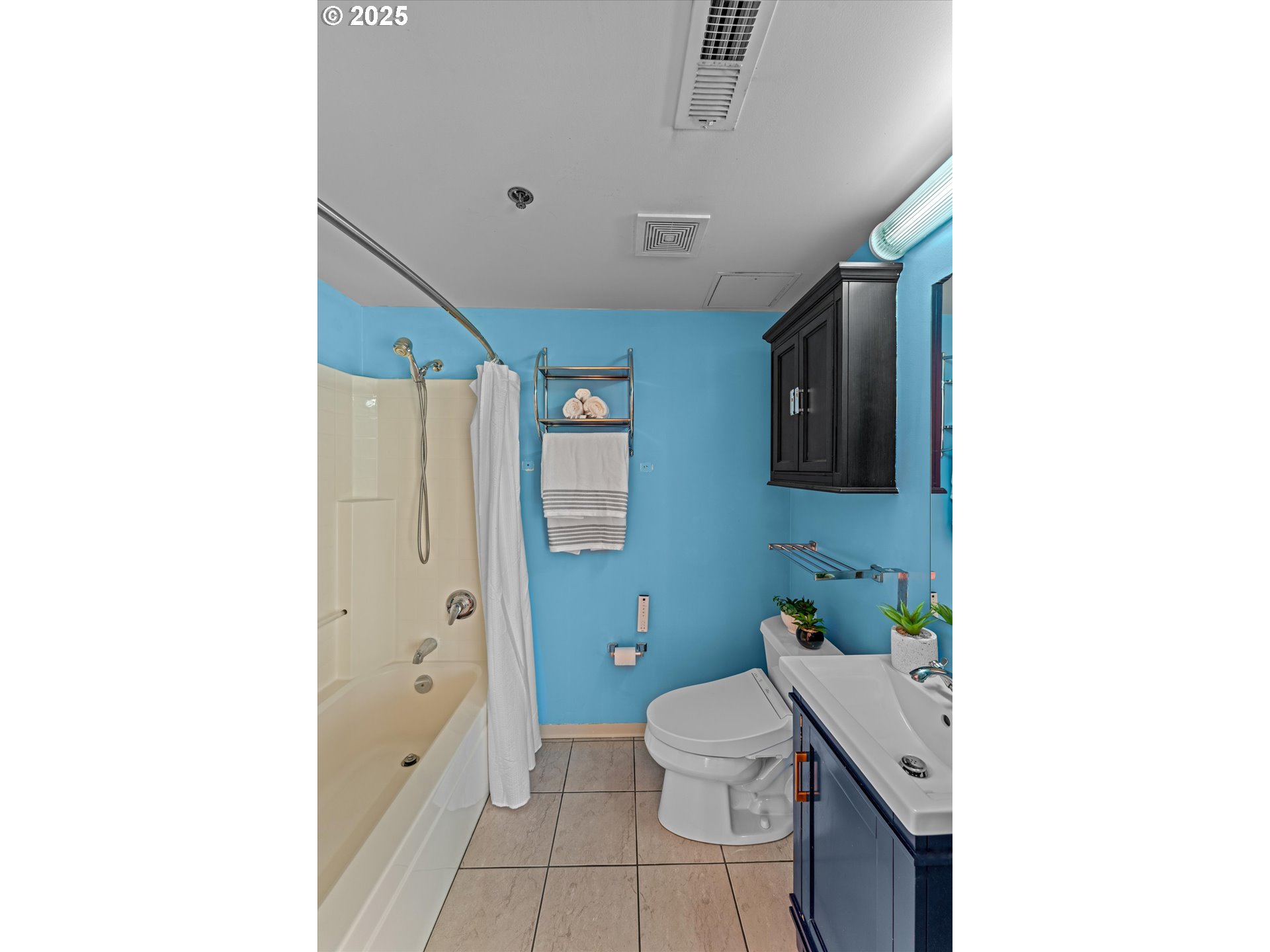 533 Northeast Holladay Street, Unit 605 Portland, OR 97232 - Photo 20 of 42 a bathroom with a sink a toilet and shower