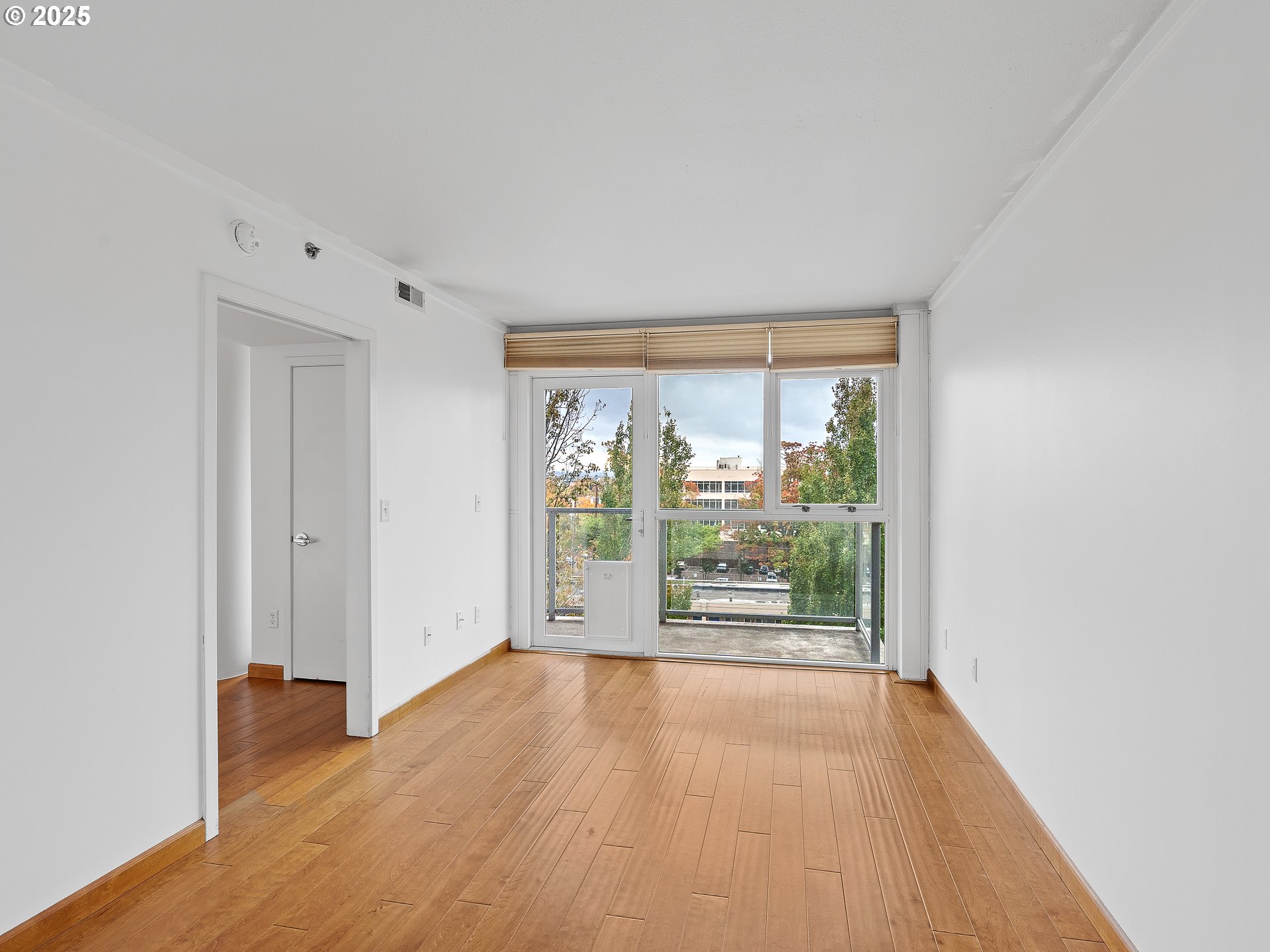 533 Northeast Holladay Street, Unit 605 Portland, OR 97232 - Photo 25 of 42 wooden floor in an empty room with a window