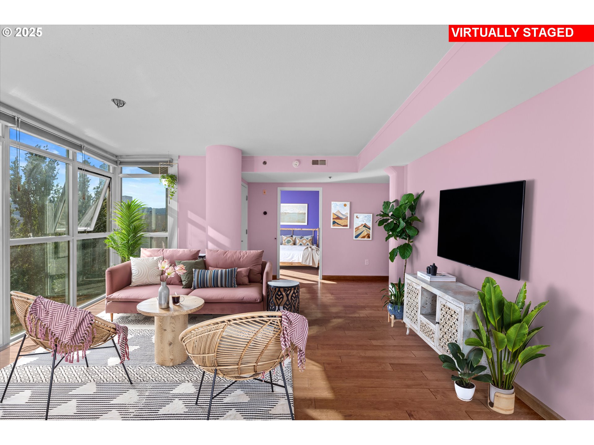 533 Northeast Holladay Street, Unit 605 Portland, OR 97232 - Photo 3 of 42 a living room with furniture a flat screen tv and a potted plant