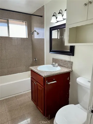 a bathroom with a sink a toilet and bathtub