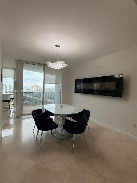 18911 Collins Avenue, Unit 2804 Sunny Isles Beach, FL 33160 - Photo 13 of 38 a living room with furniture and a large window