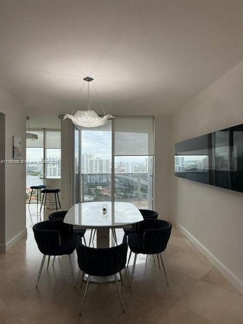 18911 Collins Avenue, Unit 2804 Sunny Isles Beach, FL 33160 - Photo 14 of 38 a view of a dining room with furniture window and outside view