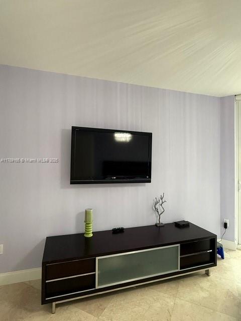 18911 Collins Avenue, Unit 2804 Sunny Isles Beach, FL 33160 - Photo 17 of 38 a living room with furniture and a flat screen tv