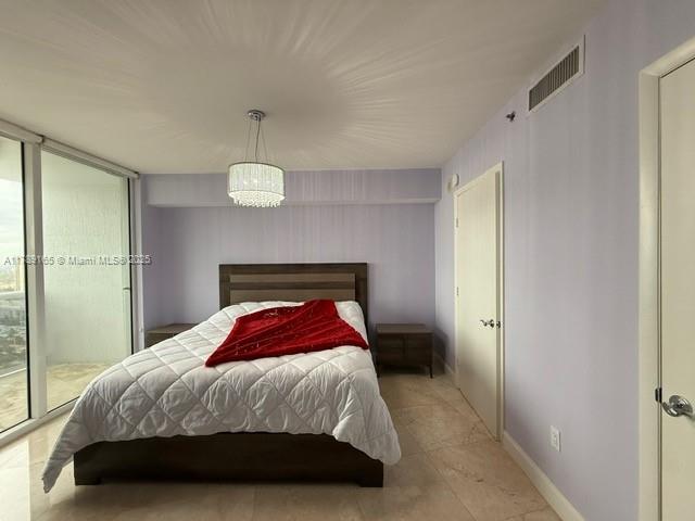 18911 Collins Avenue, Unit 2804 Sunny Isles Beach, FL 33160 - Photo 21 of 38 a bedroom with a bed and a window