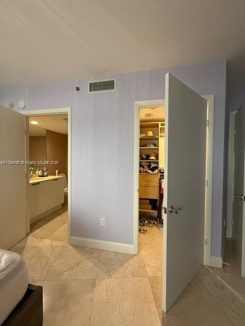 18911 Collins Avenue, Unit 2804 Sunny Isles Beach, FL 33160 - Photo 25 of 38 a view of a hallway to a livingroom with wooden floor and a bathroom