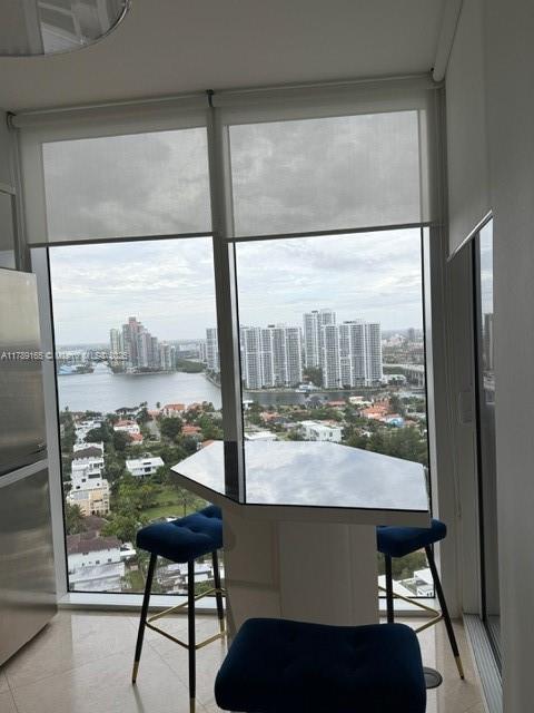 18911 Collins Avenue, Unit 2804 Sunny Isles Beach, FL 33160 - Photo 26 of 38 a room with a large window and a table