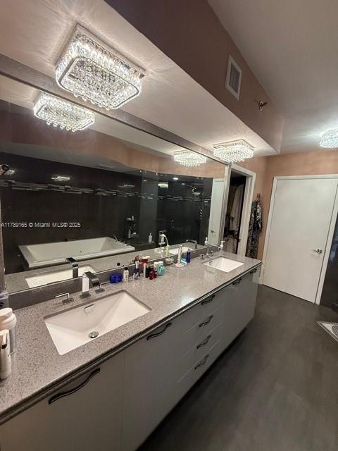 18911 Collins Avenue, Unit 2804 Sunny Isles Beach, FL 33160 - Photo 28 of 38 a bathroom with a sink a large mirror and vanity