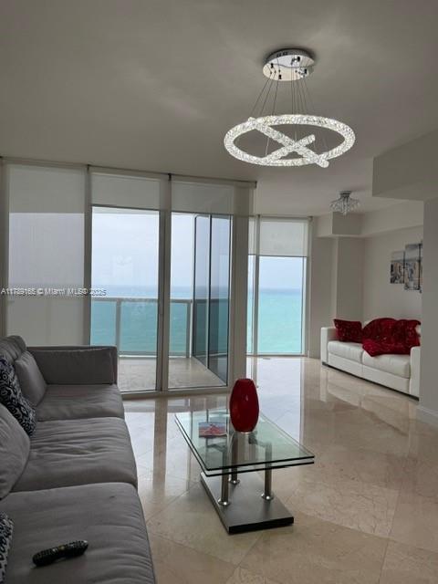 18911 Collins Avenue, Unit 2804 Sunny Isles Beach, FL 33160 - Photo 29 of 38 a living room with furniture and a large window