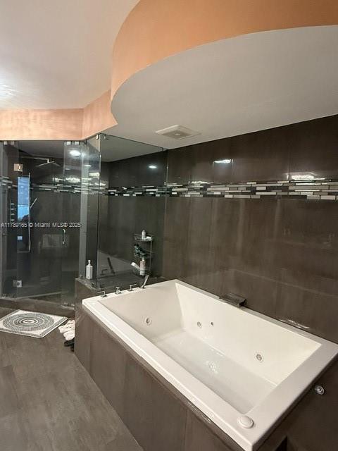 18911 Collins Avenue, Unit 2804 Sunny Isles Beach, FL 33160 - Photo 30 of 38 a bathroom with a bathtub and a shower
