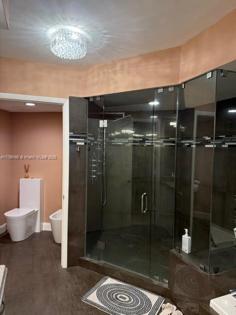 18911 Collins Avenue, Unit 2804 Sunny Isles Beach, FL 33160 - Photo 32 of 38 a bathroom with a shower a toilet and a sink